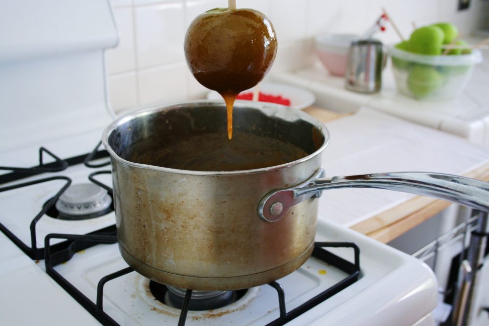 dipped caramel apple over pot