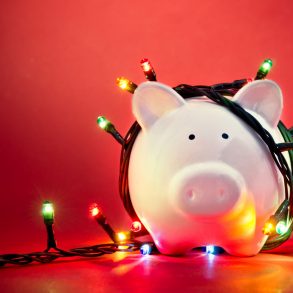 holiday stress - piggy bank wrapped in christmas lights