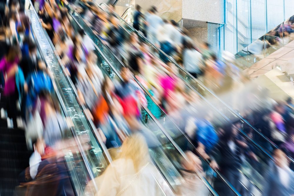 Crowded shopping mall escalator for Black Friday